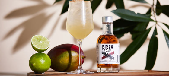A glass and a bottle of BRIX Spiced Rum