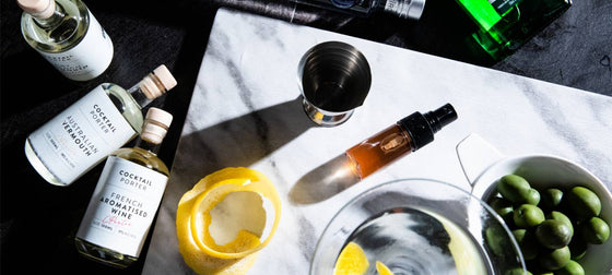 Three bottles of Cocktail Porter's Martini and other cocktail making equipment